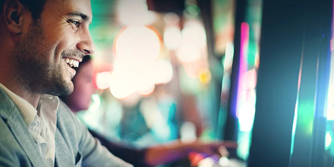 Photo of happy man at a slot machine