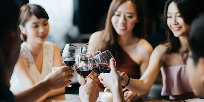 Photo of women toasting with wine glasses