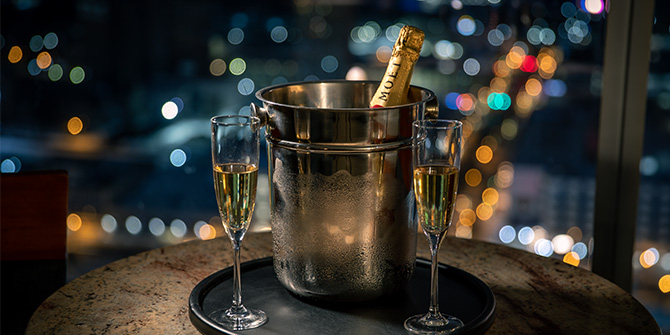 Champagne bottle and glasses with city view